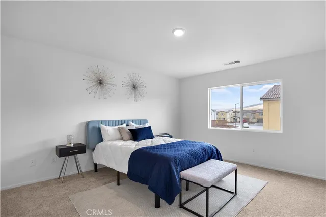 a bedroom with bed and window