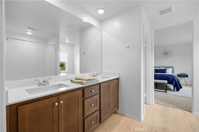 a spacious bathroom with a double vanity sink and a mirror