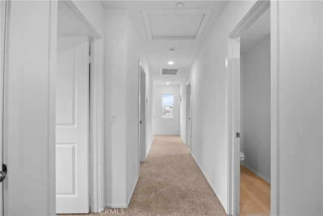 a view of a hallway with a wooden floor