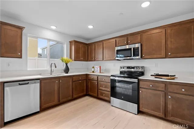 a kitchen with sink a microwave and cabinets