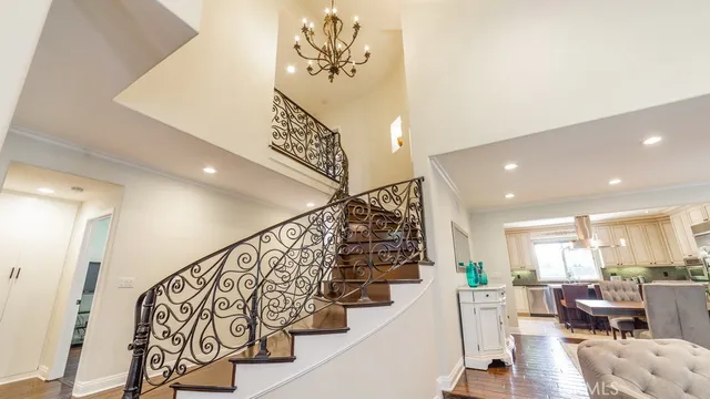 a kitchen with stainless steel appliances granite countertop a sink a stove and a wooden floors