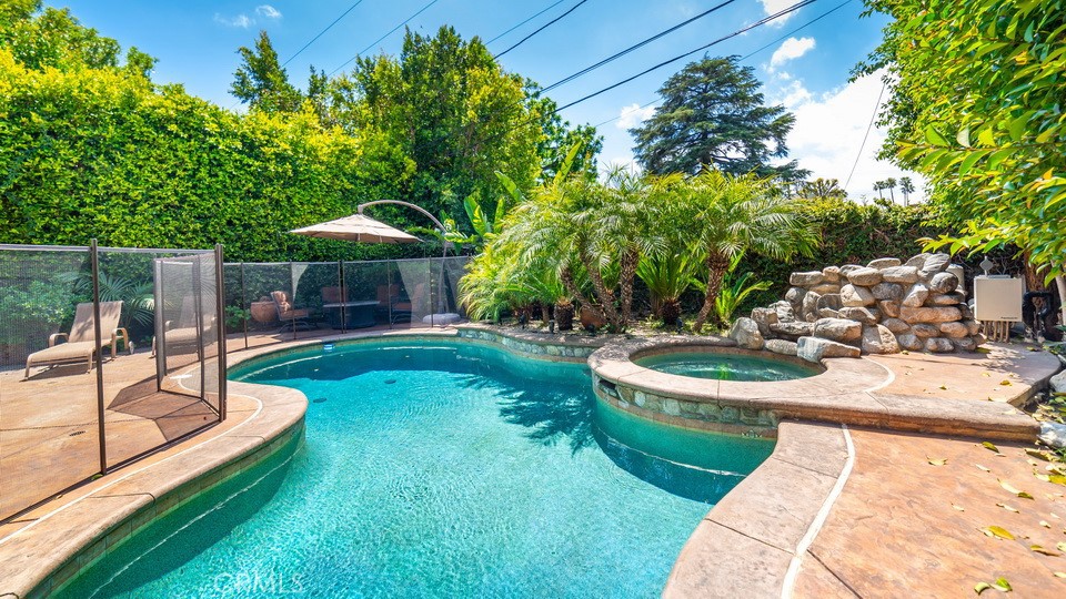4461 Stern Avenue Sherman Oaks, CA 91423 - Photo 3 of 62 a view of a backyard with table and chairs potted plants with wooden fence