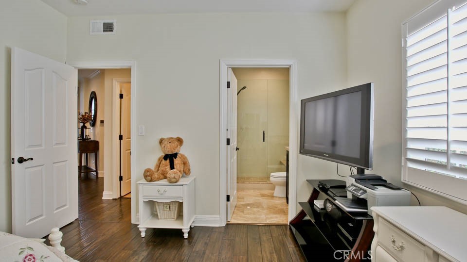 4461 Stern Avenue Sherman Oaks, CA 91423 - Photo 31 of 62 a view of a hallway with wooden floor and a bathroom