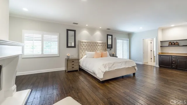 a bedroom with a bed and a view of kitchen
