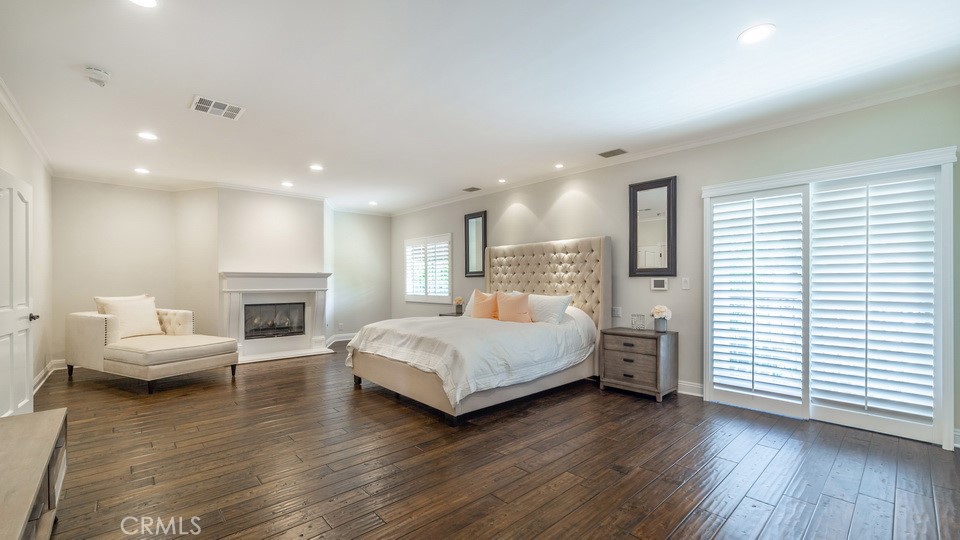 4461 Stern Avenue Sherman Oaks, CA 91423 - Photo 38 of 62 a spacious bedroom with a large bed and a wooden floor
