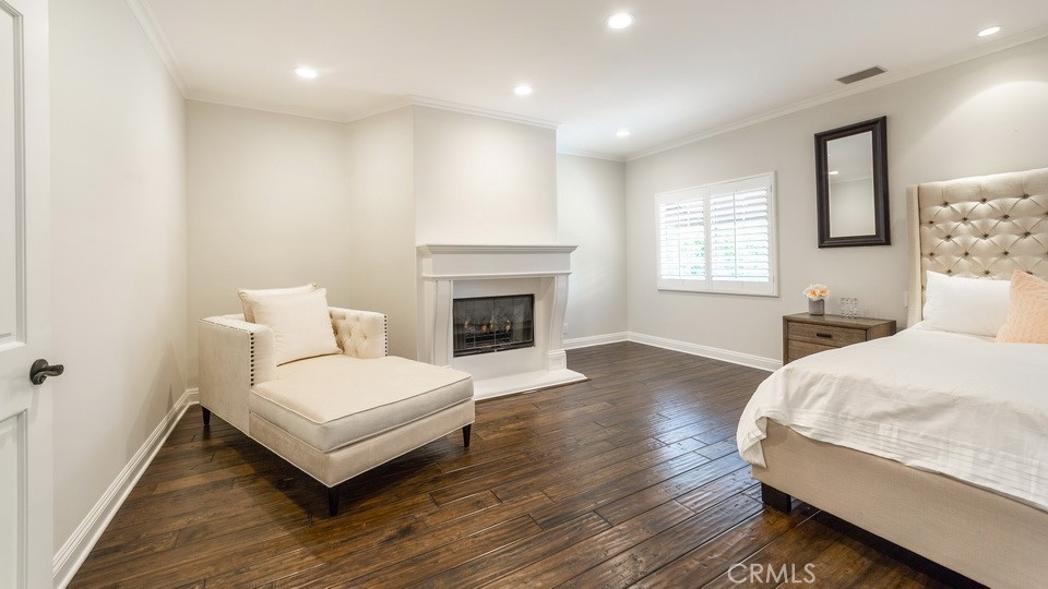 4461 Stern Avenue Sherman Oaks, CA 91423 - Photo 40 of 62 a spacious bedroom with a bed and a fireplace