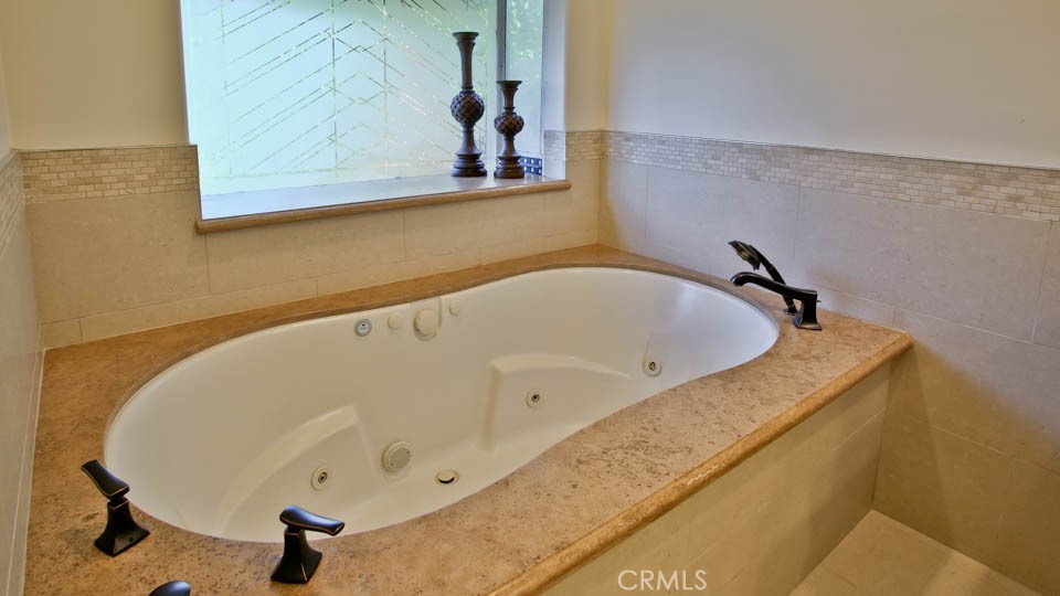 4461 Stern Avenue Sherman Oaks, CA 91423 - Photo 46 of 62 a bathroom with a tub and mirror