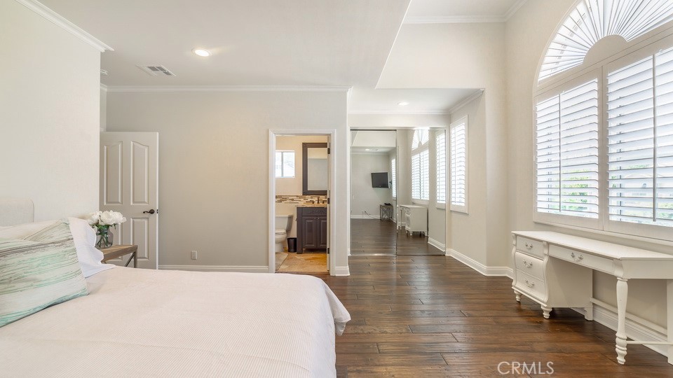 4461 Stern Avenue Sherman Oaks, CA 91423 - Photo 49 of 62 a spacious bedroom with a bed and wooden floor