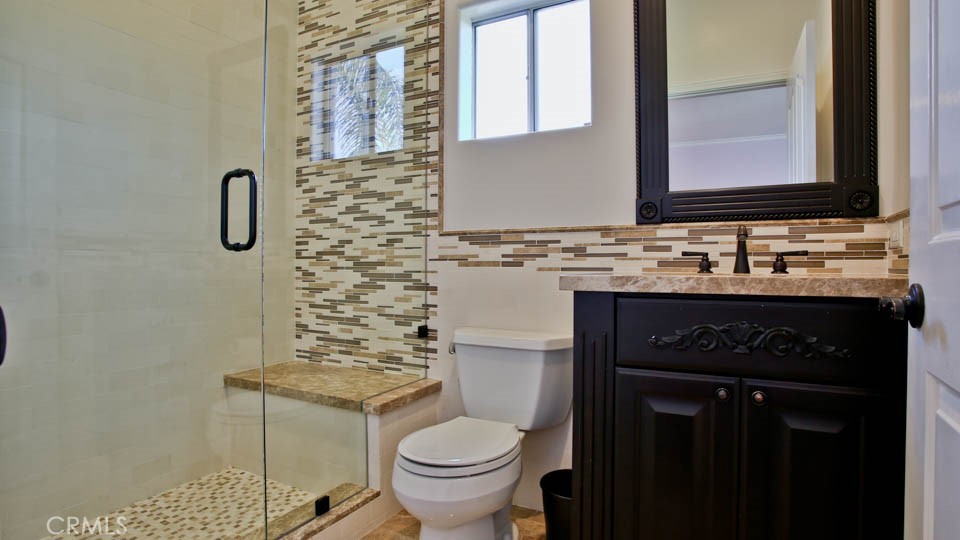 4461 Stern Avenue Sherman Oaks, CA 91423 - Photo 52 of 62 a bathroom with a granite countertop sink toilet and mirror
