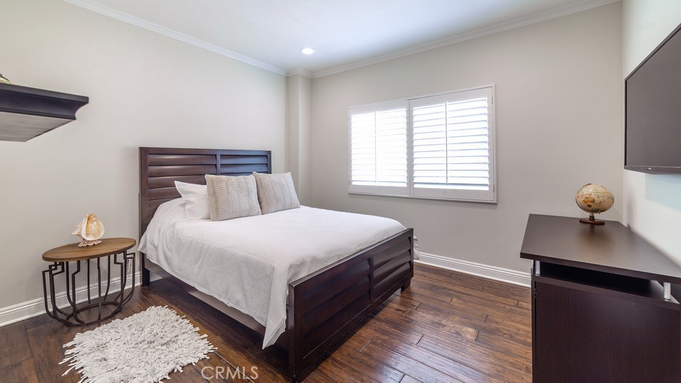 4461 Stern Avenue Sherman Oaks, CA 91423 - Photo 57 of 62 a bedroom with a bed and wooden floor