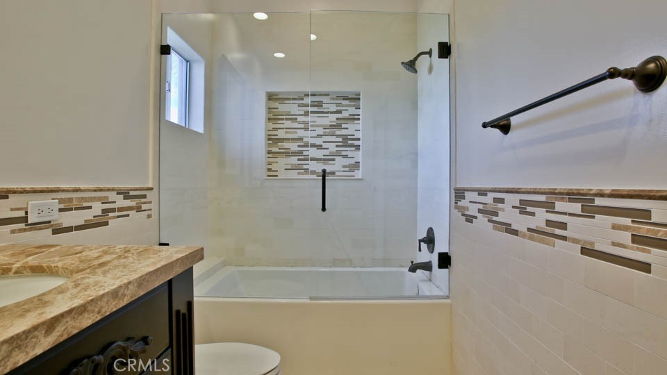 4461 Stern Avenue Sherman Oaks, CA 91423 - Photo 61 of 62 a bathroom with a granite countertop sink a toilet and bathtub