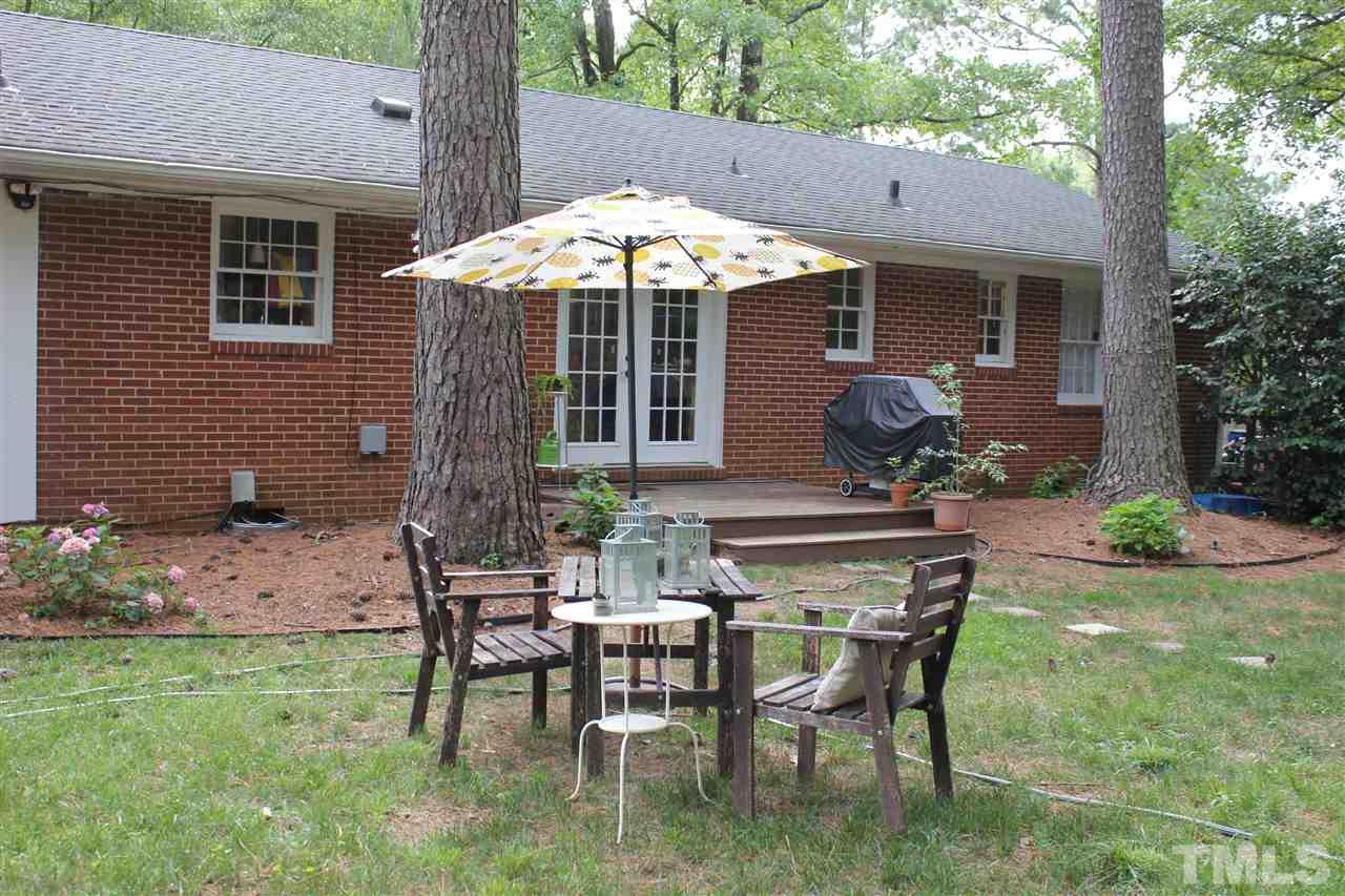 904 Chatham Lane Raleigh, NC 27610 - Photo 27 of 29 a backyard of a house with table and chairs
