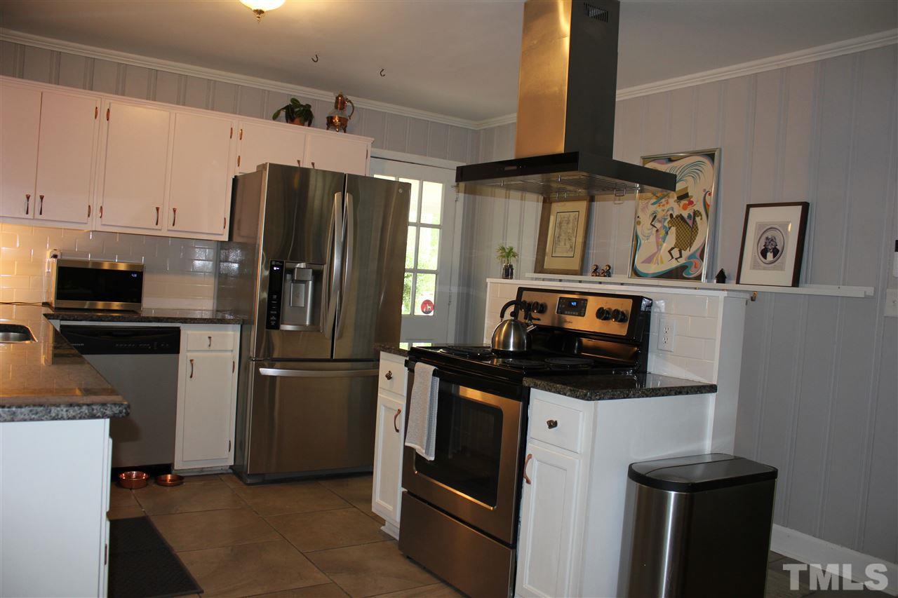 904 Chatham Lane Raleigh, NC 27610 - Photo 5 of 29 a kitchen with stainless steel appliances a refrigerator and a stove top oven