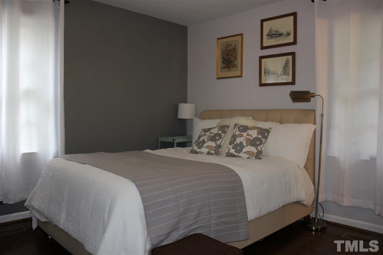 904 Chatham Lane Raleigh, NC 27610 - Photo 8 of 29 a bedroom with a bed and wall painting