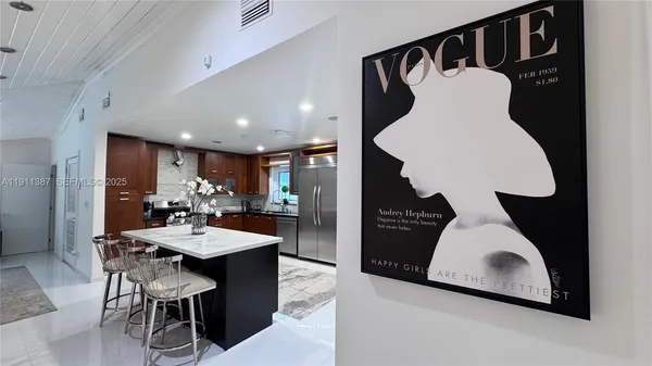 a large kitchen with a table and chairs