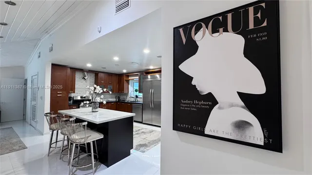 a large kitchen with a table and chairs