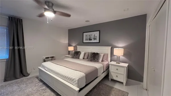 a bed room with a bed and a night stand