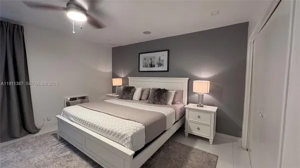 a bedroom with a bed and painting on the wall
