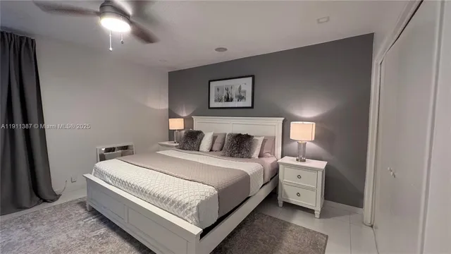 a bedroom with a bed and painting on the wall