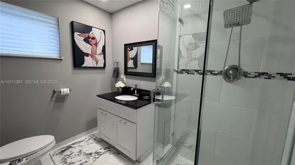 a kitchen with stainless steel appliances kitchen island granite countertop a sink and cabinets