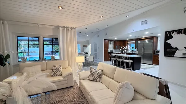 a kitchen with stainless steel appliances granite countertop a refrigerator and a stove