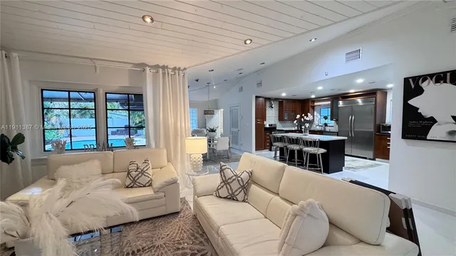 a kitchen with stainless steel appliances granite countertop a refrigerator and a stove