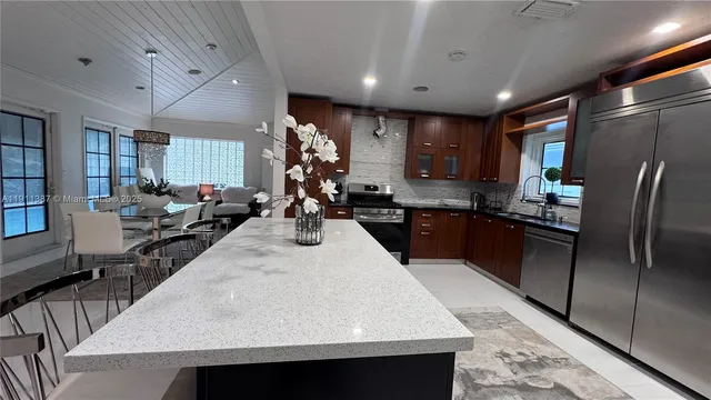 a large kitchen with a table and chairs