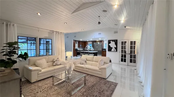 a kitchen with stainless steel appliances kitchen island granite countertop a sink and cabinets