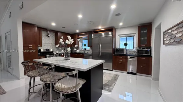 a living room with furniture stove and a refrigerator