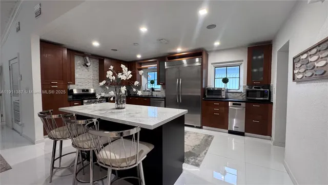 a living room with furniture stove and a refrigerator