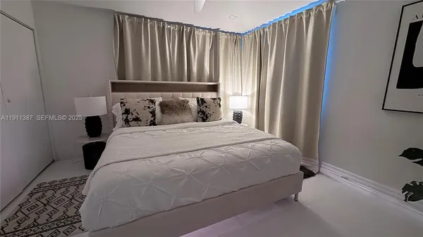 a bedroom with a bed and a potted plant