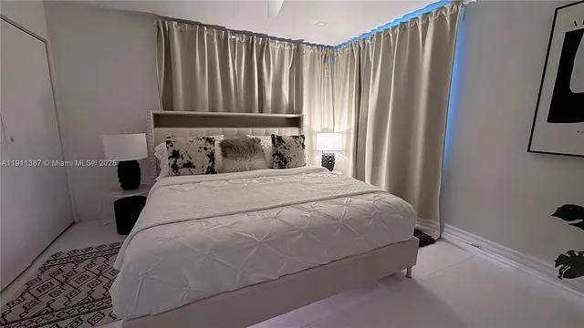 a bedroom with a bed and a potted plant