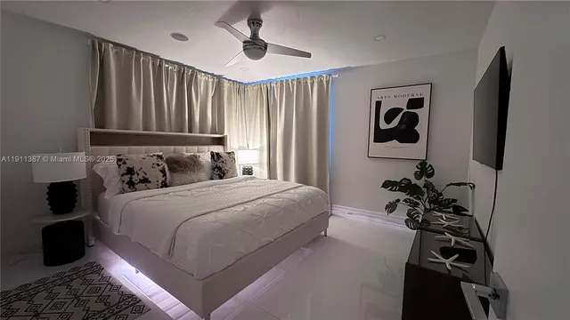 a bedroom with a bed and a potted plant