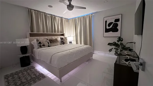 a bedroom with a bed lamp and a window