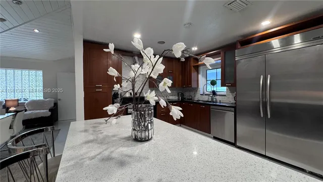 a kitchen with a refrigerator and a sink