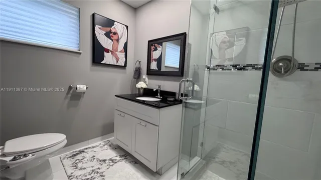 a bathroom with a sink toilet and vanity