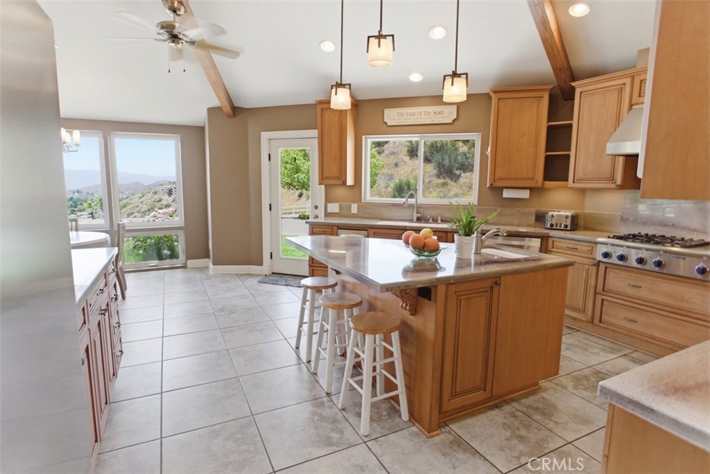 31233 Romero Canyon Road Castaic, CA 91384 - Photo 16 of 38 a kitchen with a sink a counter top space appliances and cabinets