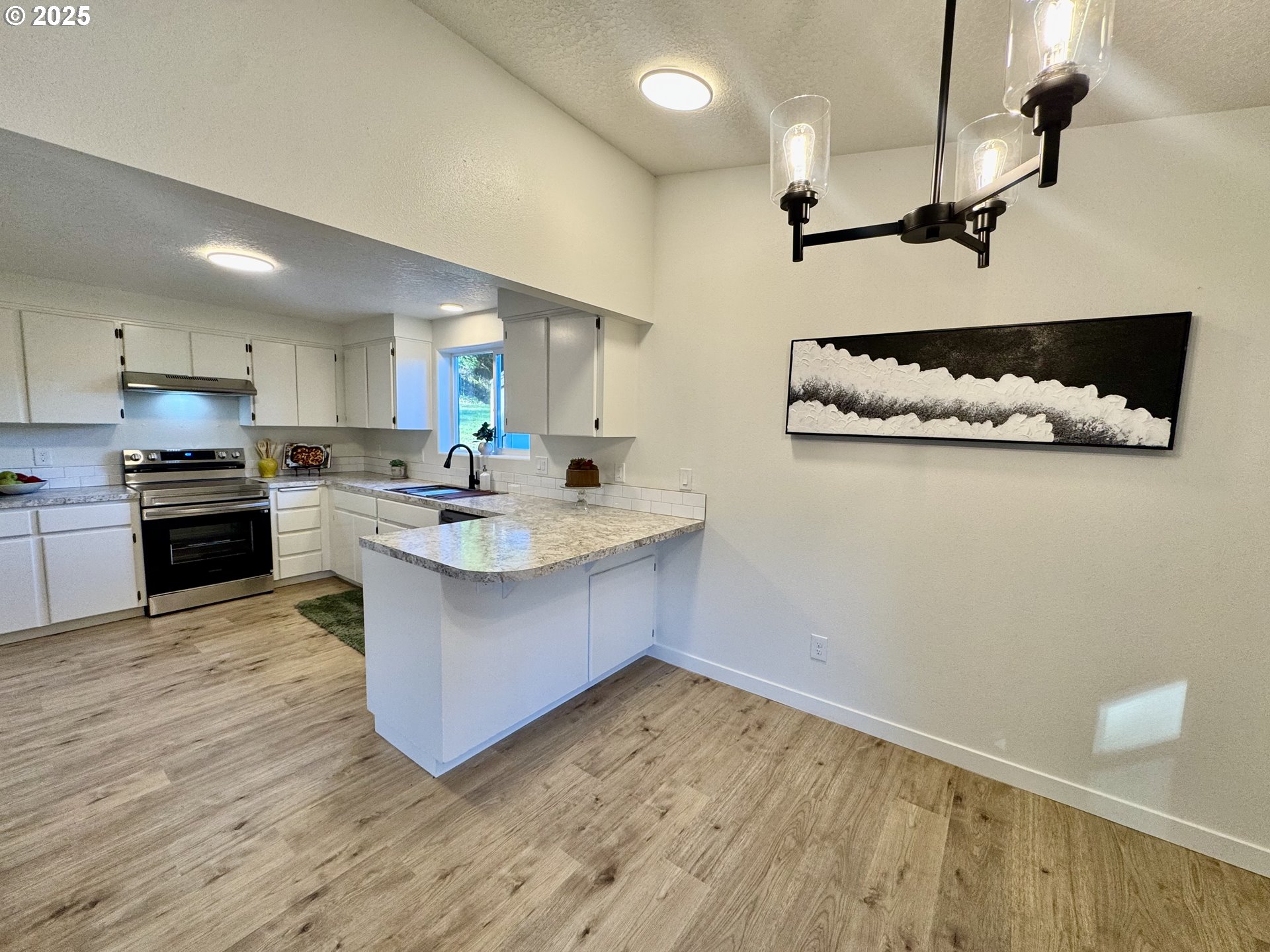 73345 Apiary Road Rainier, OR 97048 - Photo 12 of 44 a kitchen with a sink cabinets and wooden floor