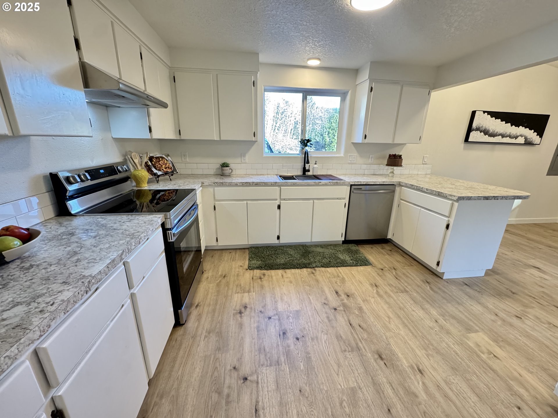 73345 Apiary Road Rainier, OR 97048 - Photo 13 of 44 a kitchen with wooden floors and white appliances