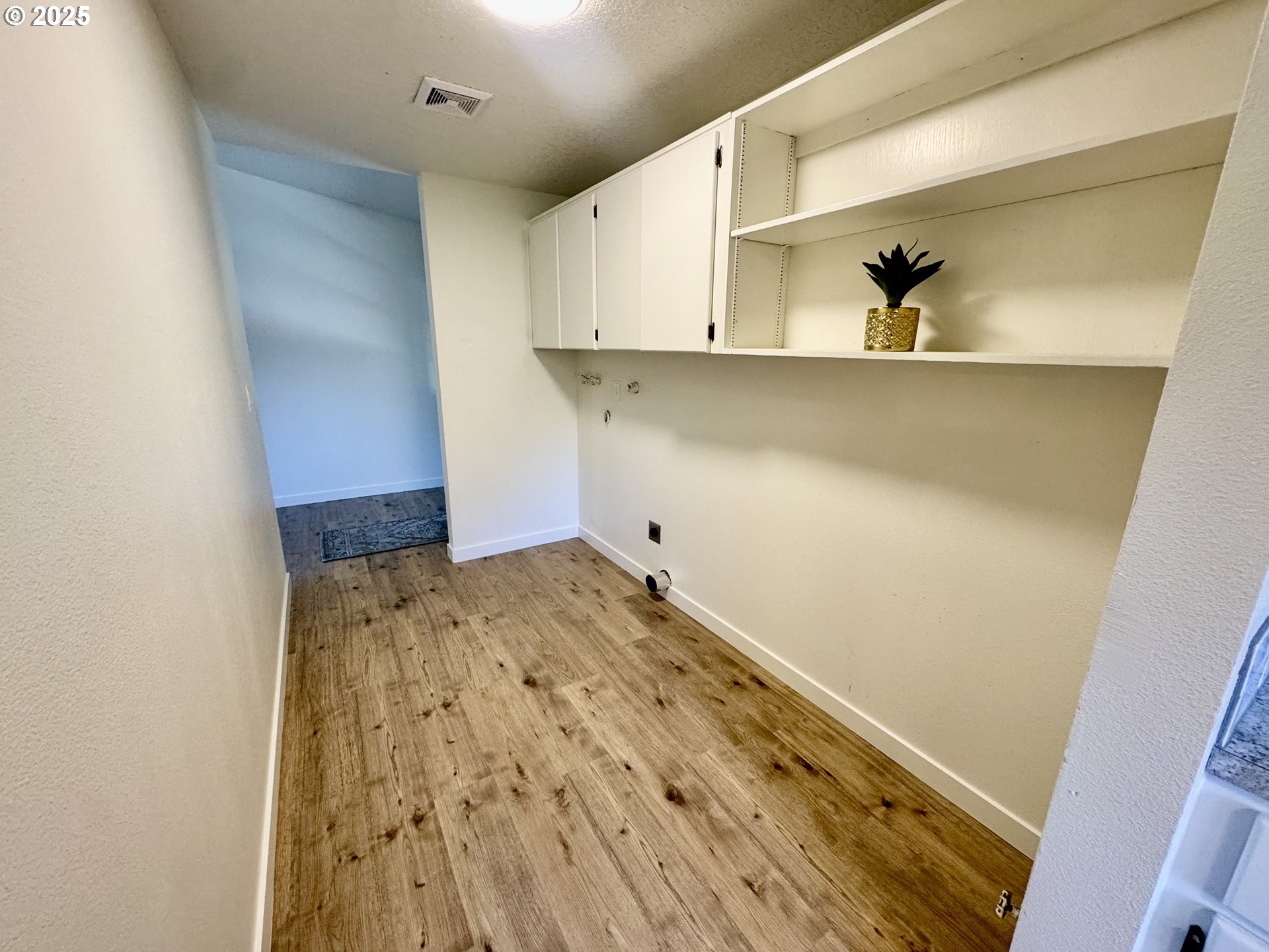 73345 Apiary Road Rainier, OR 97048 - Photo 14 of 44 a room with a wooden floor and cabinets