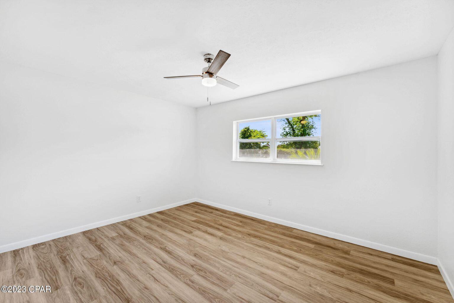 1029 Ethlyn Road Panama City, FL 32404 - Photo 18 of 29 an empty room with a window and ceiling fan