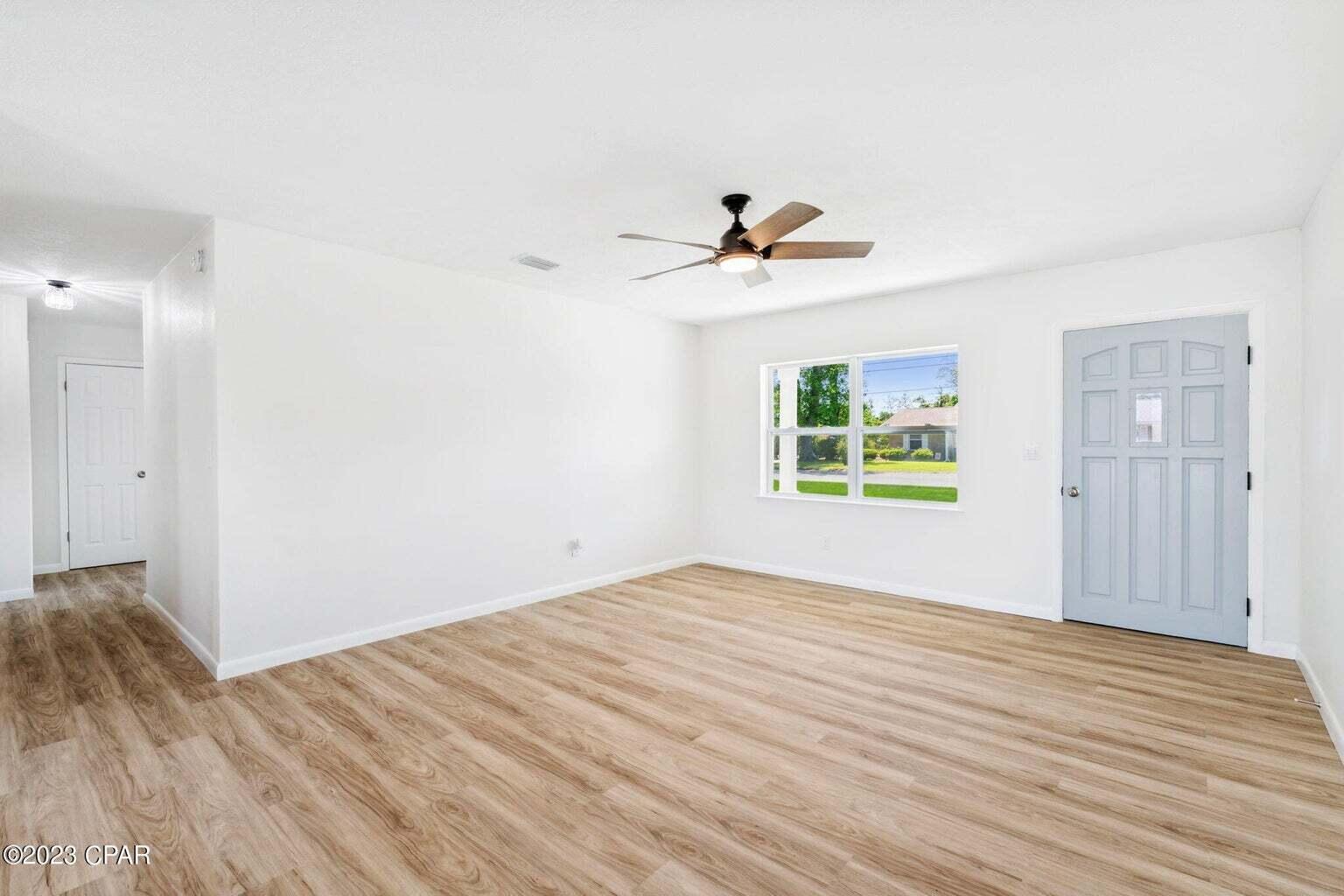 1029 Ethlyn Road Panama City, FL 32404 - Photo 5 of 29 a view of a big room with wooden floor and windows