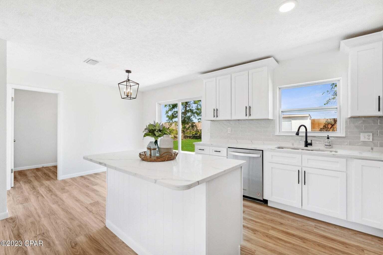 1029 Ethlyn Road Panama City, FL 32404 - Photo 10 of 29 a kitchen with stainless steel appliances granite countertop a white cabinets and a stove