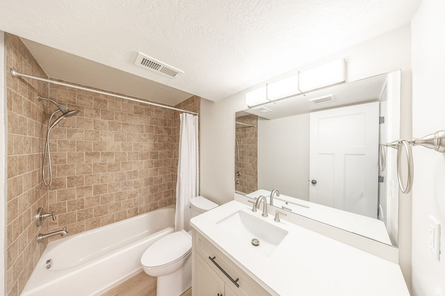 2169 Orchard Pines Loop East Bountiful, UT 84010 - Photo 27 of 32 Bathroom featuring a white vanity with a rectangular sink, brushed nickel faucet, and a large frameless mirror