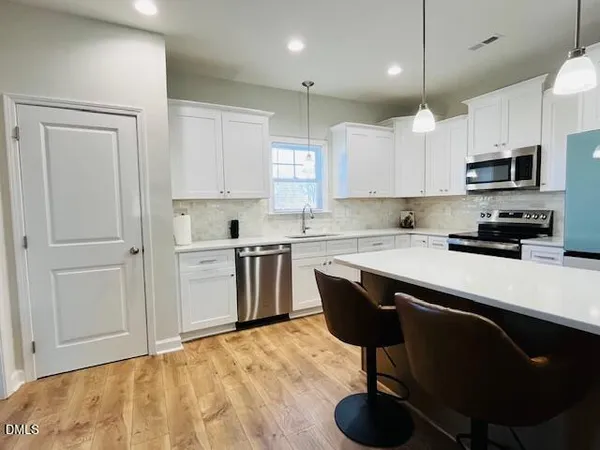 a dining room with a table chairs and a wooden floor