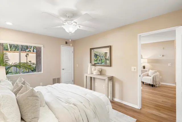 a bedroom with a large bed and a chandelier