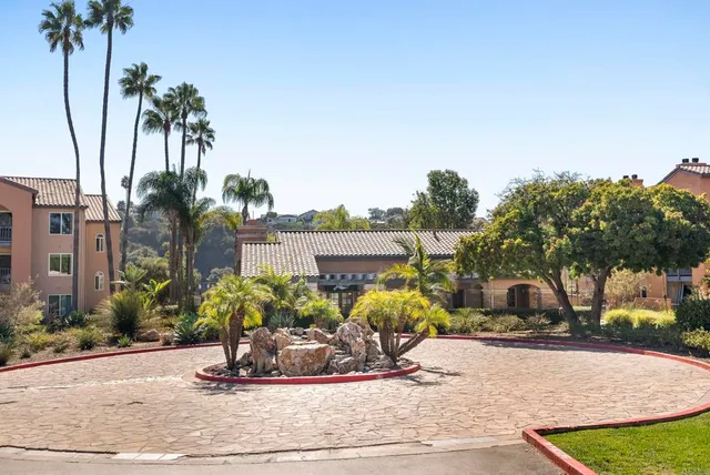 a front view of a house with a yard and potted plants