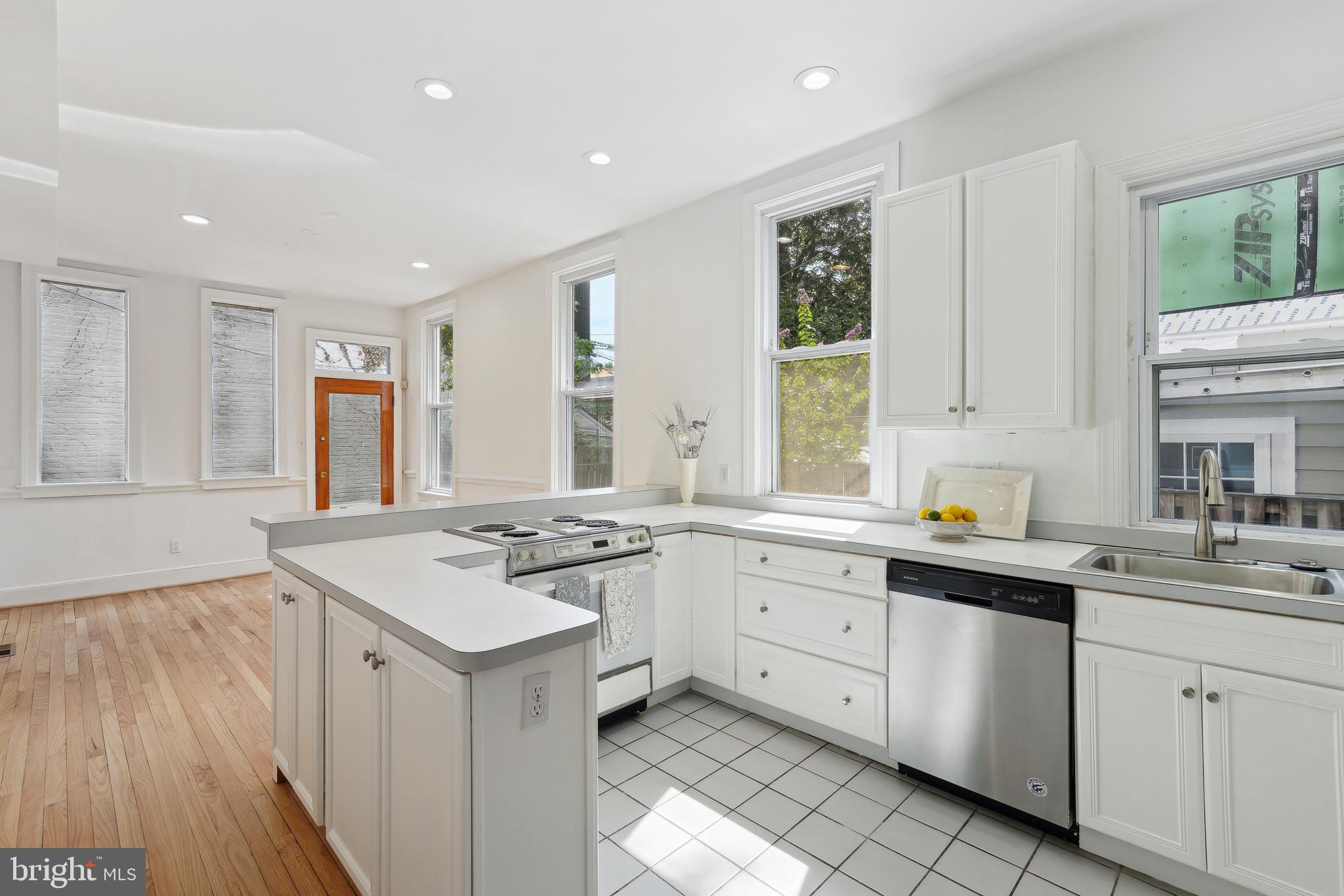 329 Constitution Avenue Northeast Washington, DC 20002 - Photo 17 of 62 a kitchen with a sink stove and cabinets