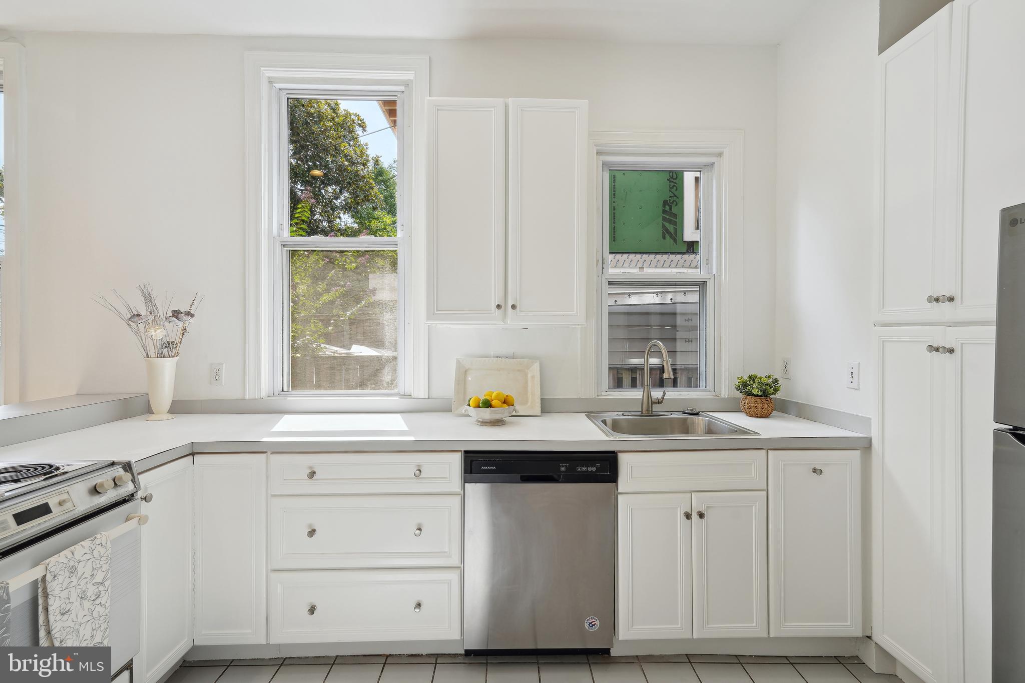 329 Constitution Avenue Northeast Washington, DC 20002 - Photo 20 of 62 a kitchen with stainless steel appliances white cabinets and a window