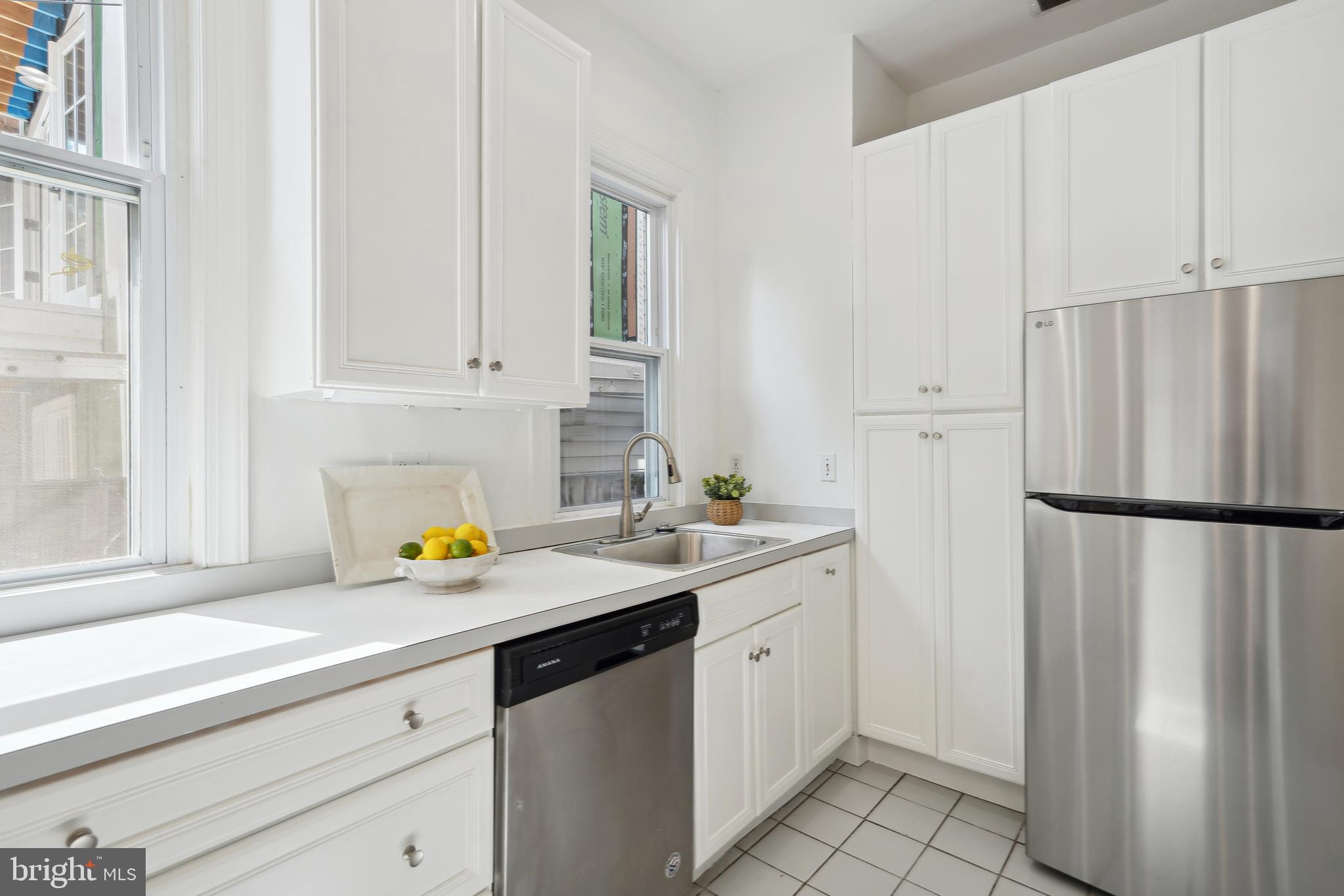 329 Constitution Avenue Northeast Washington, DC 20002 - Photo 22 of 62 a kitchen with a sink and a refrigerator